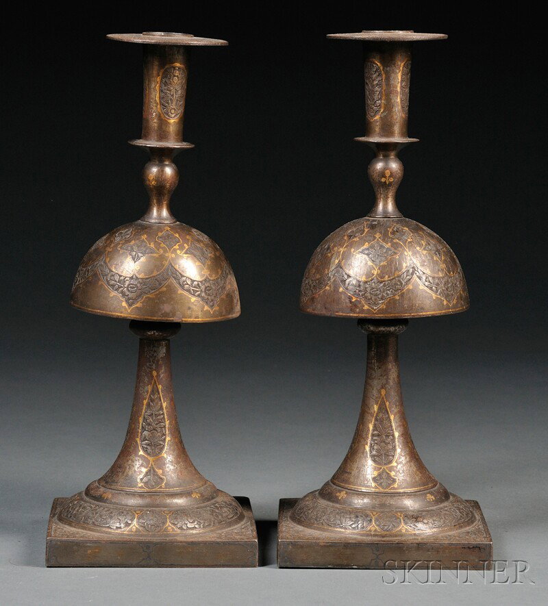 Pair of Inlaid Persian Candleholders, supported on: Pair of Inlaid Persian Candleholders, supported on a square base tapering to a domed center and rising to the holder, overall decoration of scrolling silver flowers enclosed in gilt, ht. 12 in.