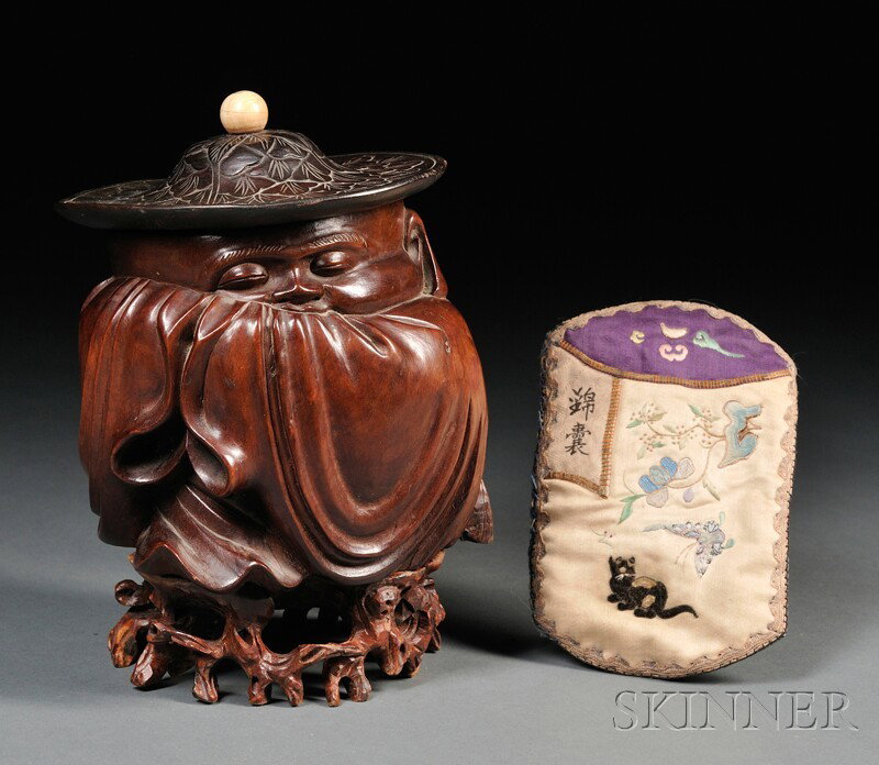 Wood Carving, China, early 20th century, depicting: Wood Carving, China, early 20th century, depicting an old man sleeping, wearing a big flat hat with an ivory finial, rosewood stand, together with a small embroidered bag, ht. 5 1/2 in.
