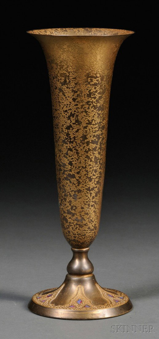 Tiffany Furnaces Trumpet Vase Dore bronze and enamel New York Trumpet form on circular pedestal base: Tiffany Furnaces Trumpet Vase Dore bronze and enamel New York Trumpet form on circular pedestal base with burgundy and blue enamel decoration marked Louis Tiffany Furnaces Inc. 166A, patina wear, ht. 