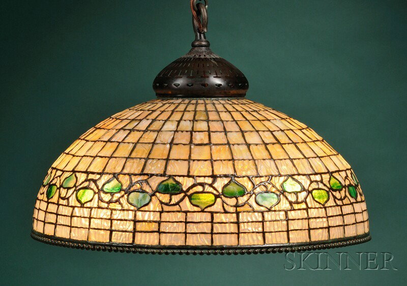 Tiffany Studios Acorn Hanging Lamp Art glass and bronze New York Dome shade in a white gridwork of t: Tiffany Studios Acorn Hanging Lamp Art glass and bronze New York Dome shade in a white gridwork of textured drapery-form glass with green acorn decorated border, lower rim with bronze beaded border, w