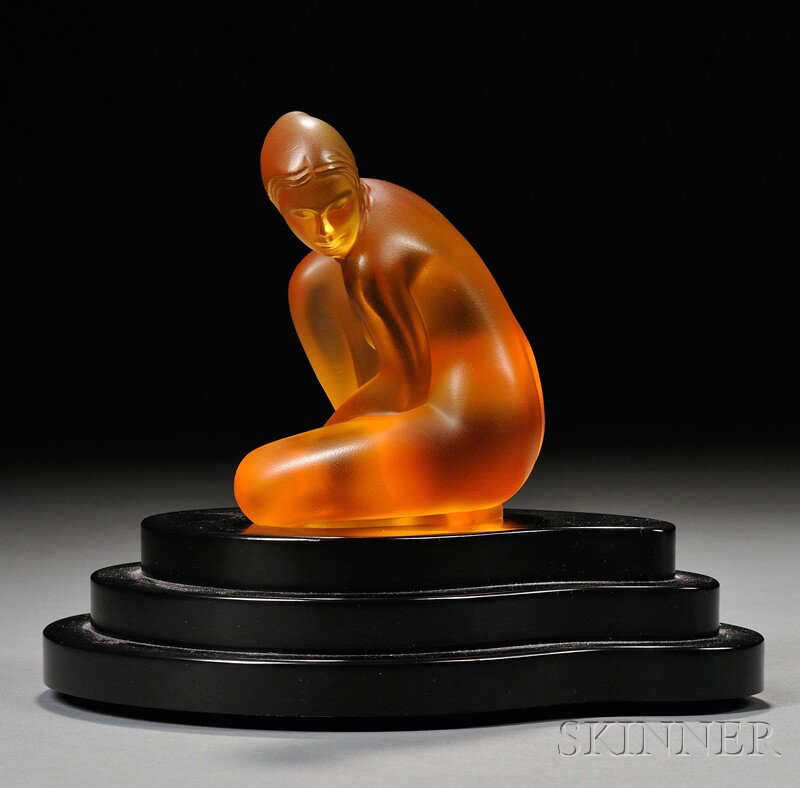 Lalique Amber Venus Lamp Art glass, plastic France, 2006 Limited edition Lalique Collector's Society: Lalique Amber Venus Lamp Art glass, plastic France, 2006 Limited edition Lalique Collector's Society Petit Nue V?nus, seated nude female in amber glass, illuminated by accompanying three-tier black pl