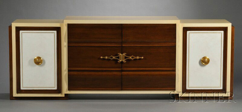 Mid-Century Modern Credenza Hardwood, enamel, simulated leather, brass Rectangular stepped top in cr: Mid-Century Modern Credenza Hardwood, enamel, simulated leather, brass Rectangular stepped top in creamy yellow enamel finish with two cabinet doors with pierced brass handles, flanked by two cabinet