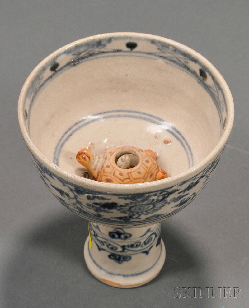 Puzzle Cup, Anamese stem cup with underglaze blue : Puzzle Cup, Anamese stem cup with underglaze blue scrolling decoration, interior with a turtle and a child, dia. 4, ht. 4 in.