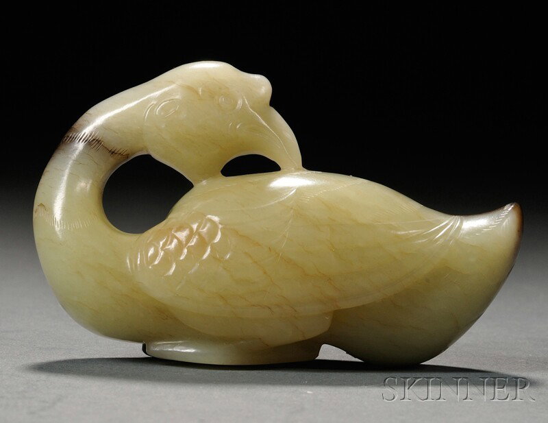 Jade Carving, China, carved as a wild goose with i: Jade Carving, China, carved as a wild goose with its head turned back, the stone of yellow-green color to one side and dark brown to the other, ht. 1 7/8, lg. 2 7/8 in.
