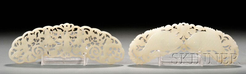 Two Jade Pendants, China, late 19th century, each: Two Jade Pendants, China, late 19th century, each of crescent shape, one carved in openwork with boys at play amidst leafy scrolls, the other with a pair of fish amidst peony branches, the stones of g