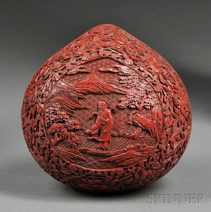 Cinnabar Box, China, peach shape, fine, deeply ca: Cinnabar Box, China, peach shape, fine, deeply carved central reserve of an Immortal in a landscape, surrounded with a band decorated with bats, peaches, and pomegranates, with a wide band beneath the