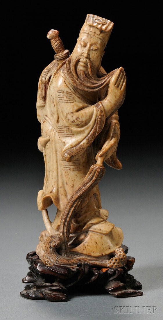 Soapstone Carving, China, depicting the standing : Soapstone Carving, China, depicting the standing figure of Guan Yu, wood stand, ht. 6 3/8 in.