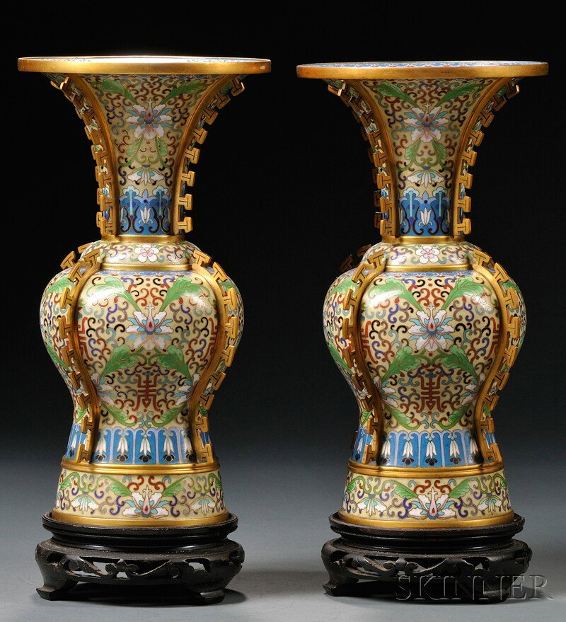Pair of Cloisonne Vases, China, in the shape of a: Pair of Cloisonne Vases, China, in the shape of an archaic drinking vessel, zun, decorated with stylized lotus borne on leafy tendrils and shuangxi characters, flanges to the edges, ht. 12 in.