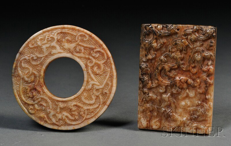 Two Jade Plaques, China, archaic-style, a rectang: Two Jade Plaques, China, archaic-style, a rectangular plaque with relief carving of chi dragons, and a pi disc carved with interlocking dragons, the stones of pale russet color, 2 5/8 x 1 7/8, dia. 2 