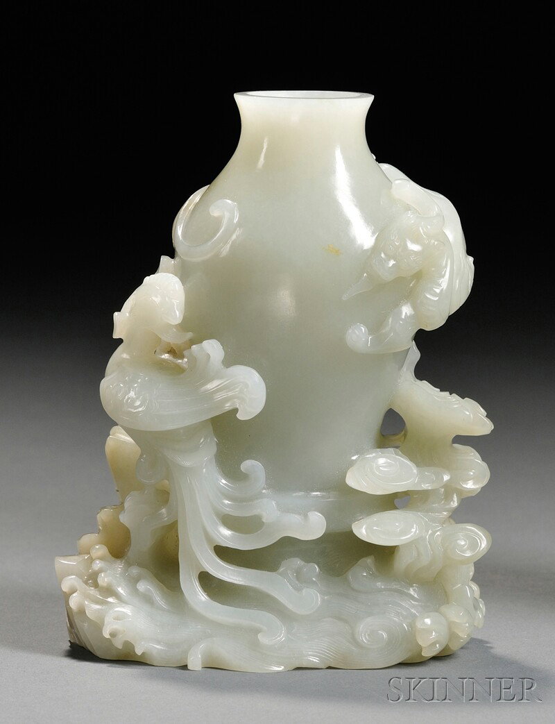 Jade Vase, China, baluster shape surrounded with: Jade Vase, China, baluster shape surrounded with a chilong and a phoenix, with rocks, waves, and ruyi clouds carved at base, the stone of a semi-translucent celadon color, ht. 5 in.