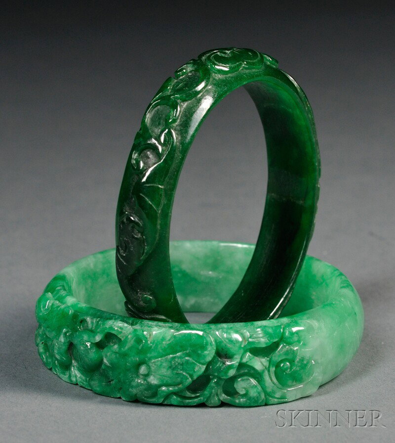 Two Jade Bracelets, China, one of intense emerald: Two Jade Bracelets, China, one of intense emerald green color, carved in relief with bats, the other of white and apple green color carved with flower scrolls, dia. 2 5/8, 2 3/4 in.