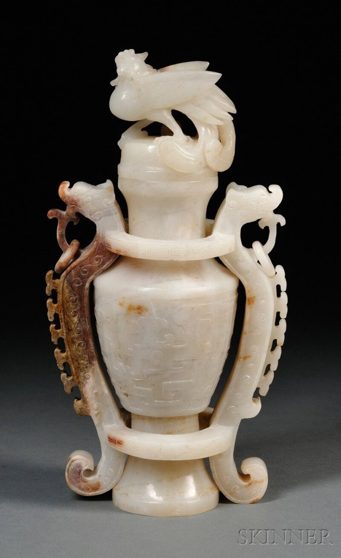 Jade Vase and Cover, China, baluster shape raised: Jade Vase and Cover, China, baluster shape raised on a pedestal foot, carved in relief with a wide band of kui dragons, openwork surround flanked by flanges and chilong with pendants, the domed cover 