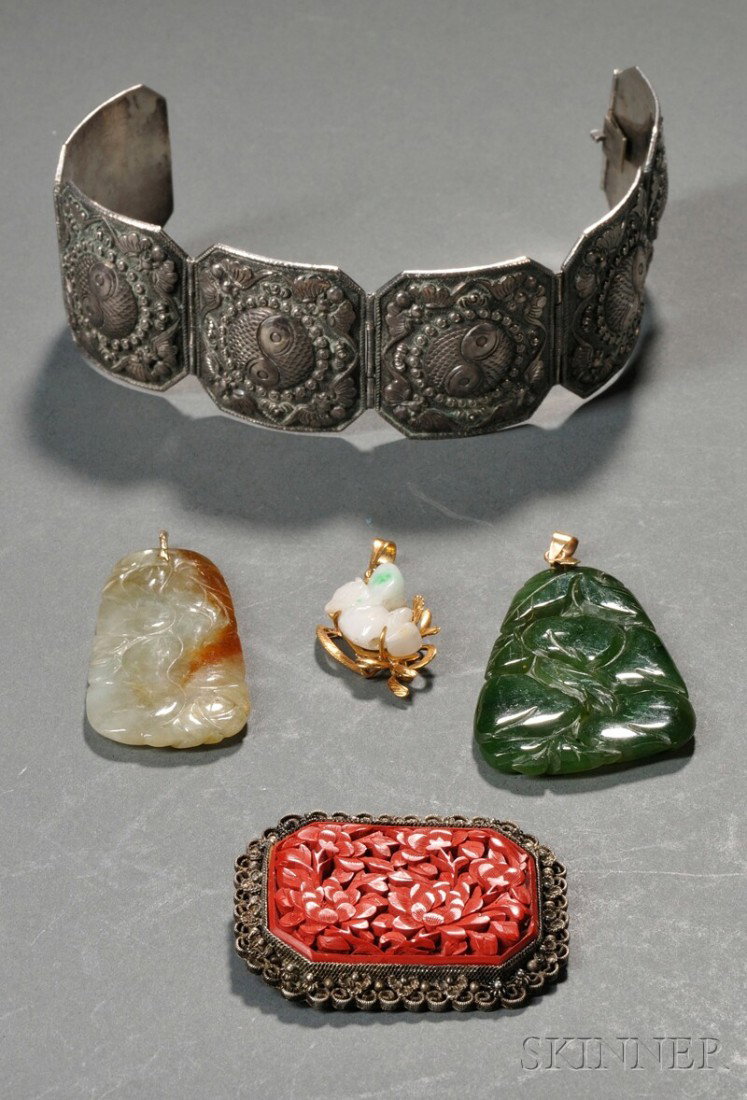 Five Pieces of Jewelry, China, a silver bracelet,: Five Pieces of Jewelry, China, a silver bracelet, a cinnabar brooch, and three jade pendants of various shapes and sizes.