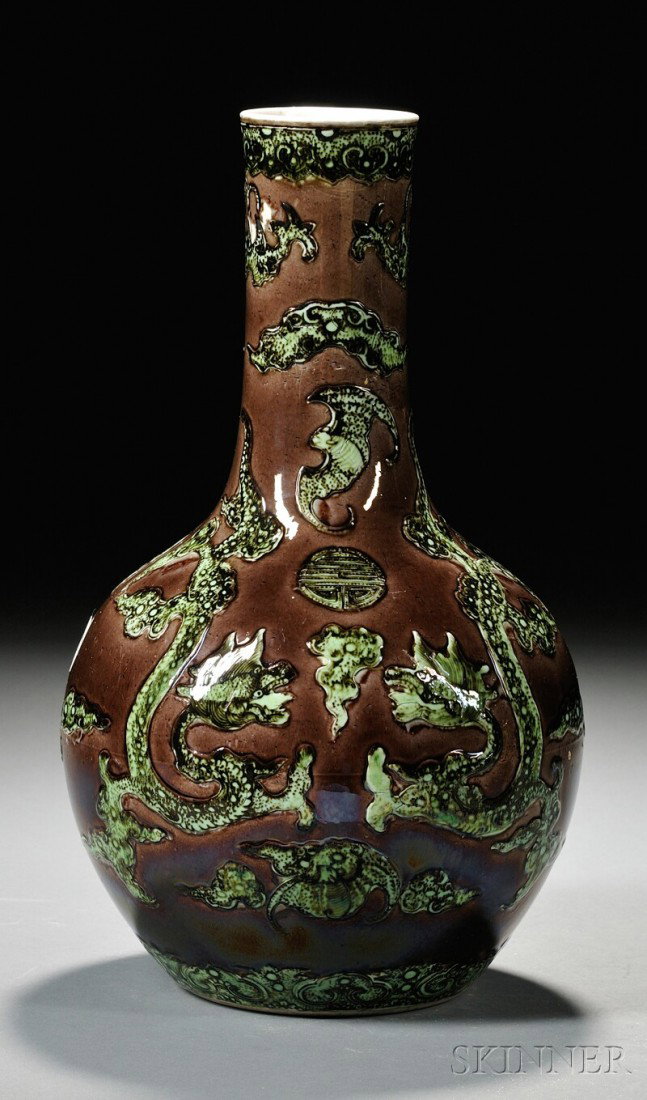 Porcelain Vase, China, of pear shape, with scrol: Porcelain Vase, China, of pear shape, with scrolling dragon and pearl and cloud motif with bats and shou characters in low relief green enamel on an aubergine ground, Kangxi mark on base, ht. 12 3/4 i