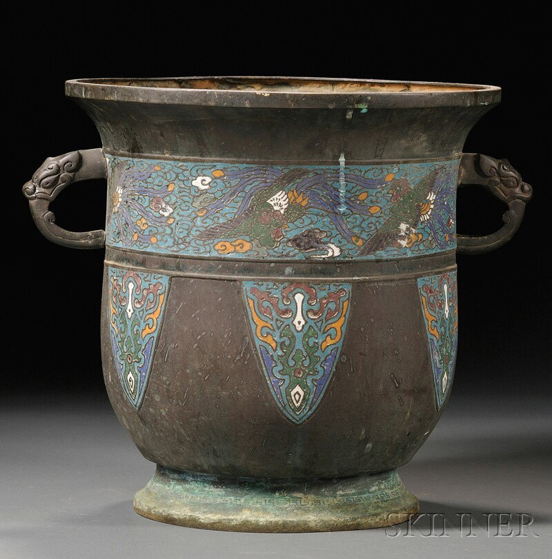 Champleve Planter, China, tall rounded shape with: Champleve Planter, China, tall rounded shape with everted rim, decorated with a deep champleve band of phoenixes in clouds, reserves of stylized dragons, the foot with key fret design, dragon handles,