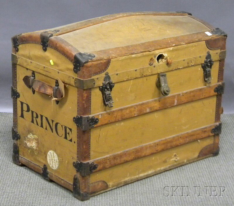 Late Victorian Wood, Metal, and Leather-bound Can: Late Victorian Wood, Metal, and Leather-bound Canvas-clad Dome-top Steamer Trunk, the side painted "Prince," the interior with red leather pouch mounted inside lid and paper label "Sage's Trunk Depot,