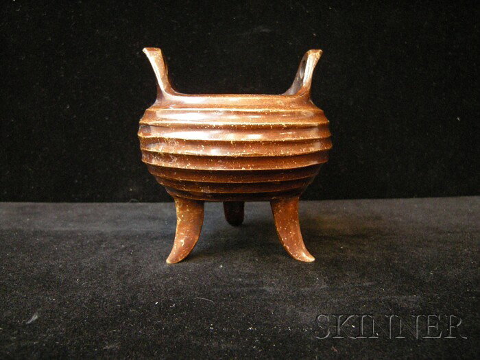 Bronze Censer, China, the compressed globular bod: Bronze Censer, China, the compressed globular body cast with grooves, raised on tripod blade feet, handles to the mouth rim, "Shi Gu Zhi Bao" mark to the base, ht. 3 3/4 in.