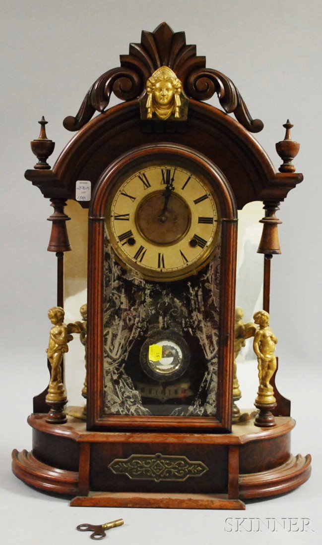 Ansonia Walnut Mantel Clock, backed by a mirror, : Ansonia Walnut Mantel Clock, backed by a mirror, cut glass pendulum, Roman numeral dial, eight-day time and strike movement, ht. 24 in.
