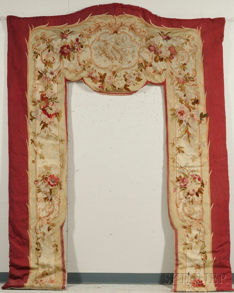 Aubusson Tapestry Door Surround, France, with centr: Aubusson Tapestry Door Surround, France, with central over-entrance cartouche filled with instruments and flowers, within frame of flower garlands and birds, on maroon ground, ht. 103, wd. 78 1/2 in.