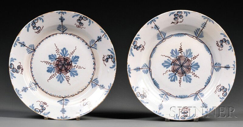 Pair of Delftware Polychrome Decorated Chargers, E: Pair of Delftware Polychrome Decorated Chargers, England, 18th century, possibly Bristol, deep manganese and blue decorated flowers and foliage to a white ground, dia. 13 1/2 in.