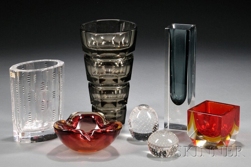 Seven Modern Glass Pieces, a Hadeland cut crystal : Seven Modern Glass Pieces, a Hadeland cut crystal vase with notched decoration, ht. 7; a smoky gray cut glass vase, ht. 9 3/4; a cased glass vase with smoky blue interior, ht. 10; a square cased glass