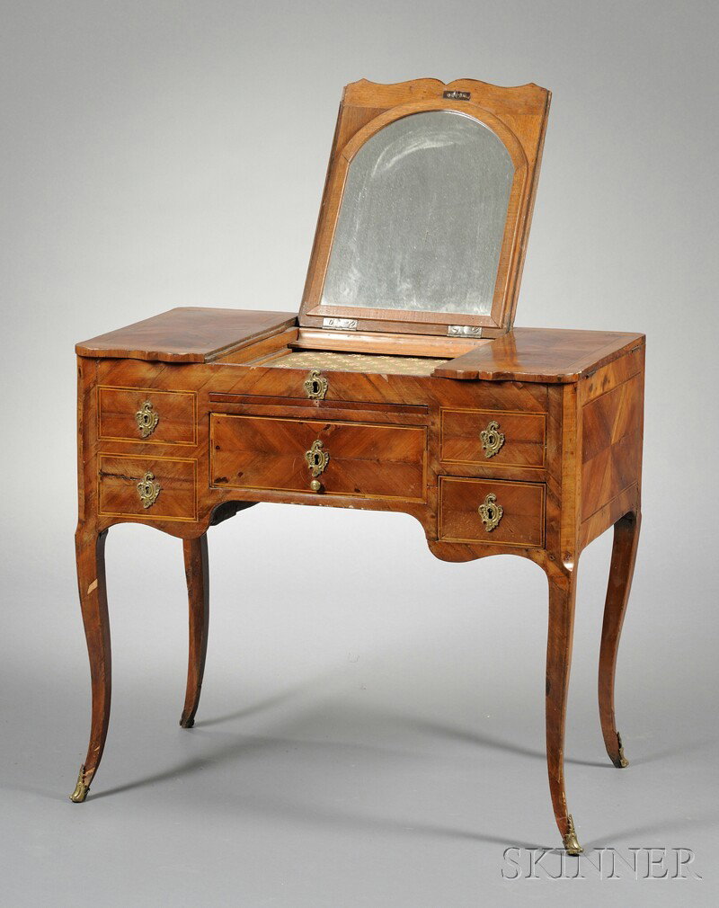 Marquetry-inlaid Dressing Table, late 19th century: Marquetry-inlaid Dressing Table, late 19th century, the hinged rectangular top with shaped front edge, the central panel lifting to reveal a mirror and shallow compartment, the side panels enclosing d