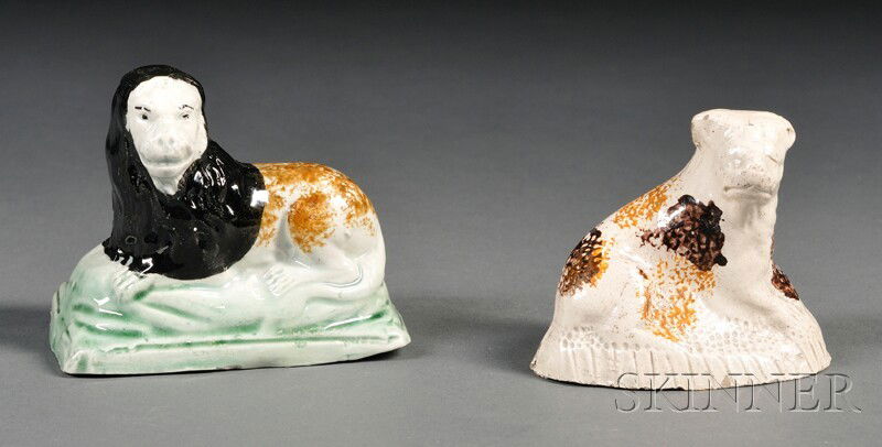 Two Staffordshire Earthenware Animals, England, la: Two Staffordshire Earthenware Animals, England, late 18th/early 19th century, model of a dog with brown and ochre sponging, ht. 2 1/2; with a model of a lion, with brown mane and sponged ochre back, t