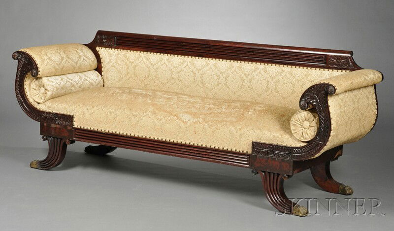 Duncan Phyfe Carved Mahogany Upholstered Sofa, Ame: Duncan Phyfe Carved Mahogany Upholstered Sofa, America, 19th century, reeded crest with flowerheads over sloping fern-carved armrests, chair rail and downswept legs with further reeding, on paw-form c