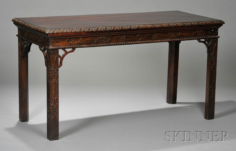 Mahogany Side Table, the rectangular top with edge: Mahogany Side Table, the rectangular top with edge carved with flowerheads and ribband, over frieze, brackets, and square legs with fretwork veneer decoration, ht. 31 7/8, wd. 60, dp. 26 3/8 in.