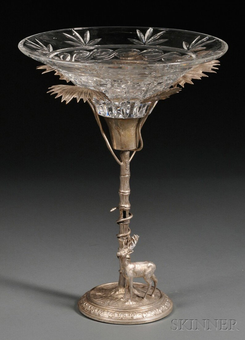 Silvered Metal Figural Tazza Centerpiece, late 19th: Silvered Metal Figural Tazza Centerpiece, late 19th century, the cut glass bowl supported by five fronds of a palm tree and a flared sconce, with a snake coiled around the trunk and an adjacent stag, 