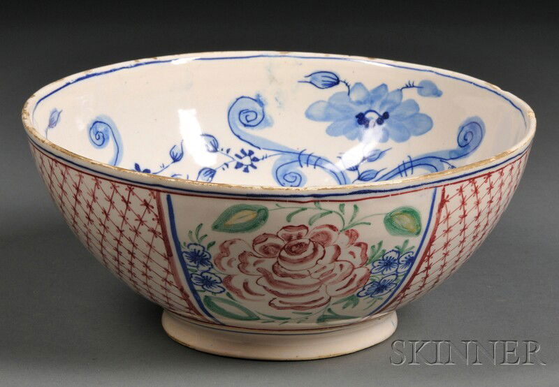 Tin-glazed Earthenware Bowl, 18th/19th century, the: Tin-glazed Earthenware Bowl, 18th/19th century, the interior decorated with blue flowers and foliage, the exterior polychrome decorated with alternating panels of flowers and lattice, dia. 9 3/4 in.