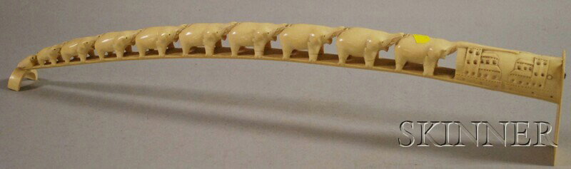 Large Carved African Ivory Tusk, carved as a joine: Large Carved African Ivory Tusk, carved as a joined procession of elephants, the end piece carved with a fish on one side and buildings on the other, lg. 27 1/2 in.