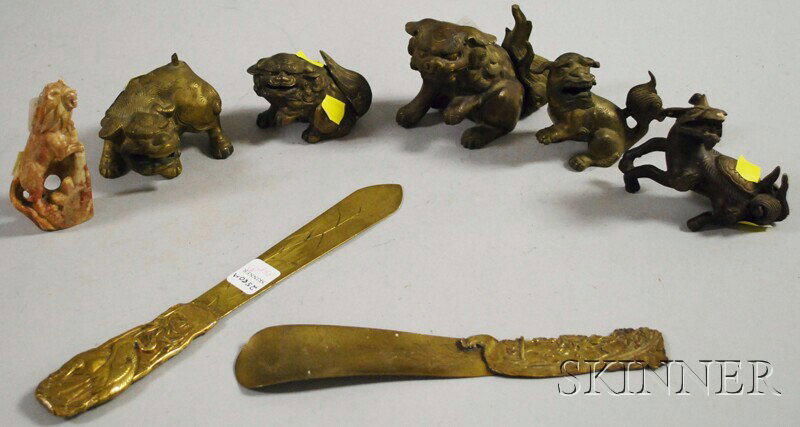 Group of Asian Metal and Stone Items, five bronze : Group of Asian Metal and Stone Items, five bronze foo lion sculptures, a carved soapstone lion, a brass letter opener (repair), and a brass shoehorn.