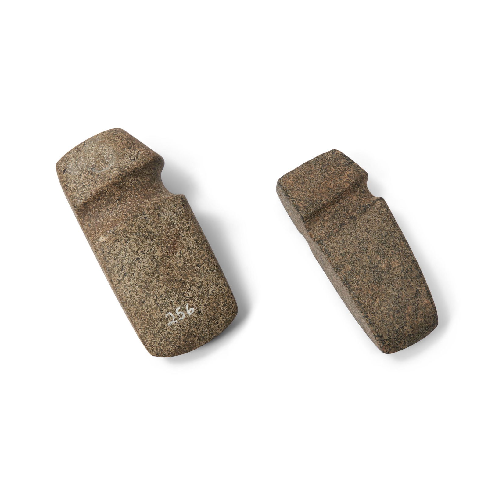 Two prehistoric slant groove stone axes: Two prehistoric slant groove stone axes Possibly from Iowa, speckled granite each with a smooth cut groove for attachment to haft. lg. 7 and 6 3/8 in. Footnotes Provenance: Purchased from Rick Sherida