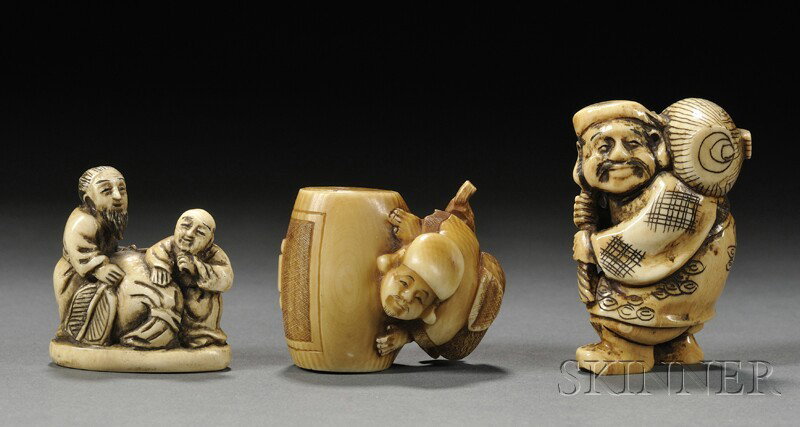 Three Netsuke, Japan, two Daikoku with sake barrel: Three Netsuke, Japan, two Daikoku with sake barrel, and two men with a fan and bag, ht. to 2 in.