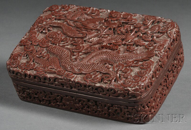 Cinnabar Box, China, 19th/20th century, depicting: Cinnabar Box, China, 19th/20th century, depicting dragons and clouds with a lotus band, lg. 6 1/8 in.