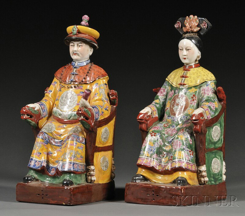 Pair of Enameled Emperor and Empress Figures, Chin: Pair of Enameled Emperor and Empress Figures, China, 20th century, seated in dragon chairs and wearing robes depicting flowers and rank badges, "Fu Jian Xui Guan" impressed mark to base, ht. 19 3/4 in