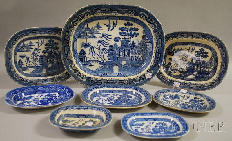 Seven Assorted Transfer-decorated Blue Willow Pat: Seven Assorted Transfer-decorated Blue Willow Pattern Ceramic Platters and an Open Serving Bowl, various makers, platter lg. 9 1/4 to 19 in.