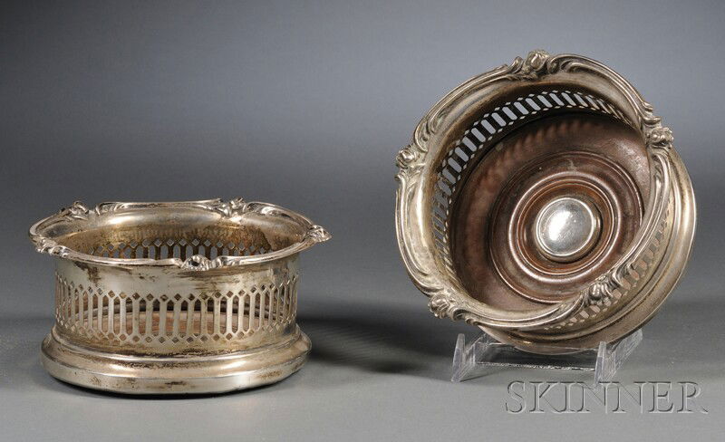 Pair of Edwardian Reticulated Silver Wine Coasters,: Pair of Edwardian Reticulated Silver Wine Coasters, Birmingham, 1905, Elkington & Co. Ltd., maker, the coasters with pierced gallery and flower blossom and scrolling foliate rim, with turned wood inse