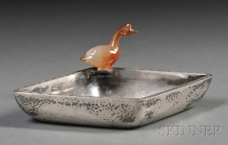 Small Japanese Silver Dresser Tray with Carved Car: Small Japanese Silver Dresser Tray with Carved Carnelian Duck, 20th century, the diamond-shaped dish with hammered finish to sides and Greek key border to top edge, a small carved carnelian duck perch