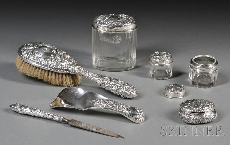 Assembled Seven-piece Sterling Silver-mounted Dres: Assembled Seven-piece Sterling Silver-mounted Dresser Set, comprising Gorham hairbrush, shoehorn, nail file, and two dresser jars, a Simons Brothers small lidded glass jar, and an S. Cottle & Co. lidd