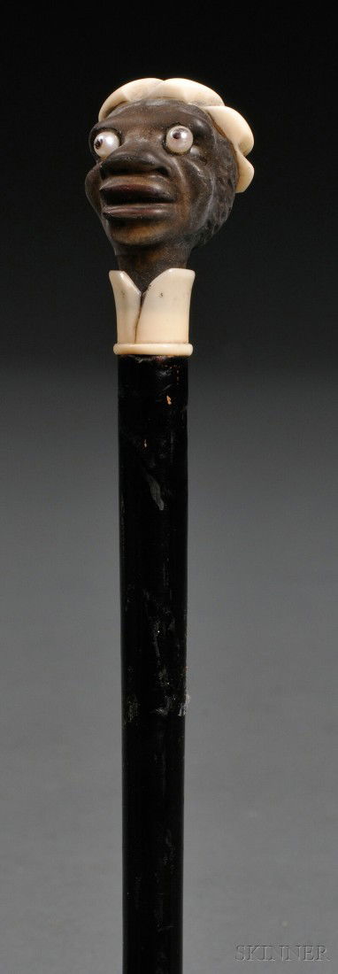 Blackamoor-handled Ebony and Ivory Cane, the handl: Blackamoor-handled Ebony and Ivory Cane, the handle carved as a male head with two bulging, pearl-set eyes, ht. 36 1/2 in.