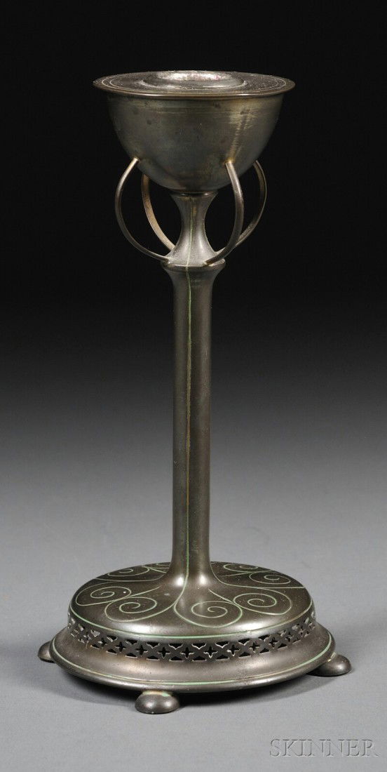 Pairpoint Manufacturing Co. Brass Candlestick, Ame: Pairpoint Manufacturing Co. Brass Candlestick, America, late 19th century, the substantial sconce joined to a tapered stem by four curved tendrils, on circular chased and reticulated base with four fe