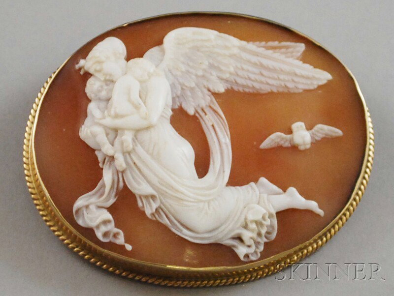 14kt Gold-framed Shell-carved Cameo Brooch, the ca: 14kt Gold-framed Shell-carved Cameo Brooch, the cameo depicting Nyx, winged Goddess of the Night, carrying her twin children Hypnos, god of sleep, and Thanatos, god of death, with an owl (one of her a