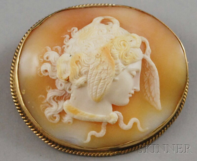 Victorian 14kt Gold-framed Shell-carved Cameo Broo: Victorian 14kt Gold-framed Shell-carved Cameo Brooch, possibly depicting the head of Perseus in profile, with wings in his curly hair and a snake around his neck, wd. 1 7/8, lg. 1 3/4 in.