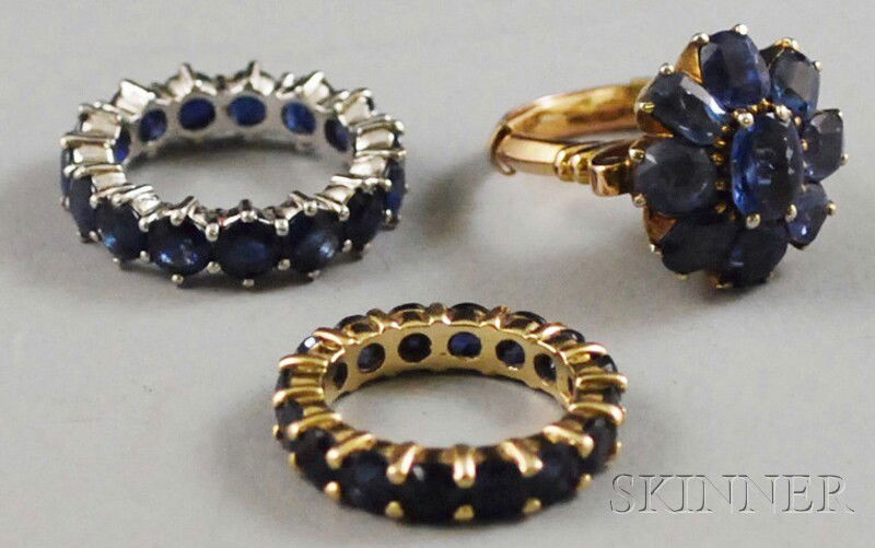 Three Sapphire Rings, a platinum eternity band, a: Three Sapphire Rings, a platinum eternity band, a 14kt yellow gold eternity band, and a 10kt gold flowerhead ring, total 12.7 dwt, sizes 6 1/2, 5 1/2, and 6 1/2, respectively.