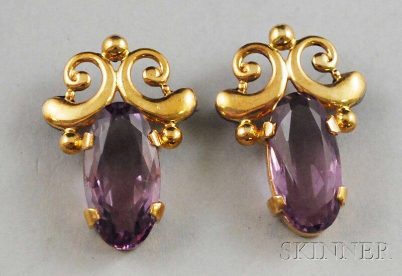 Pair of 14kt Gold and Amethyst Pins, each set with: Pair of 14kt Gold and Amethyst Pins, each set with a single oval-cut amethyst with gold balls and C-scrolls, total 6.8 dwt, lg. 1 1/8 in.