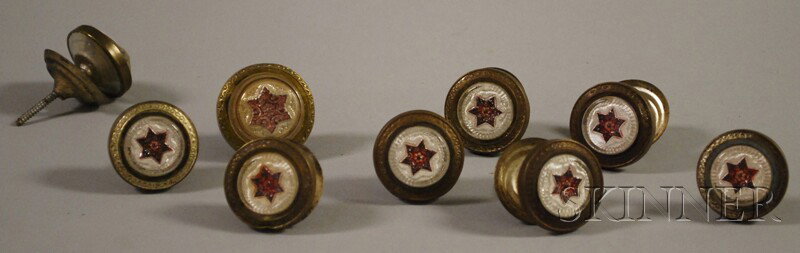 Nine 19th Century Brass, Glass, and Enamel Drawer: Nine 19th Century Brass, Glass, and Enamel Drawer Pulls, each centered with a red six-point star motif, set of eight and a larger single pull, dia. 1 1/2, 1 3/4 in.