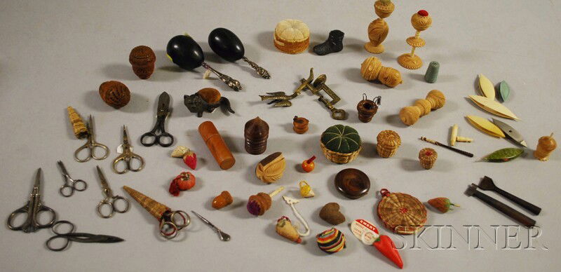 Group of Assorted Sewing Accessories, including a: Group of Assorted Sewing Accessories, including a brass bird-form sewing clamp, several embroidery scissors, tagua nut combination thread holder/pincushion/needle cases, pincushions, strawberry-form e