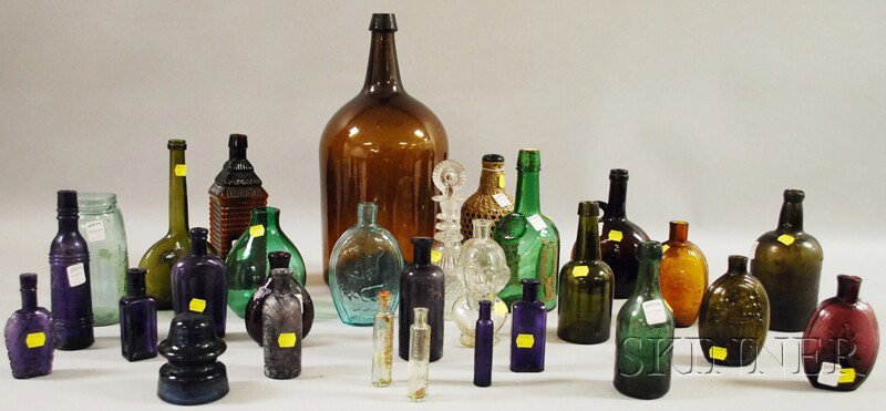 Approximately Thirty Assorted Mostly Colored Glas: Approximately Thirty Assorted Mostly Colored Glass Bottles and Items, twenty-six reproduction and period bottles and flasks, a jar, insulator, and two decanters, period includes an olive cornucopia fl